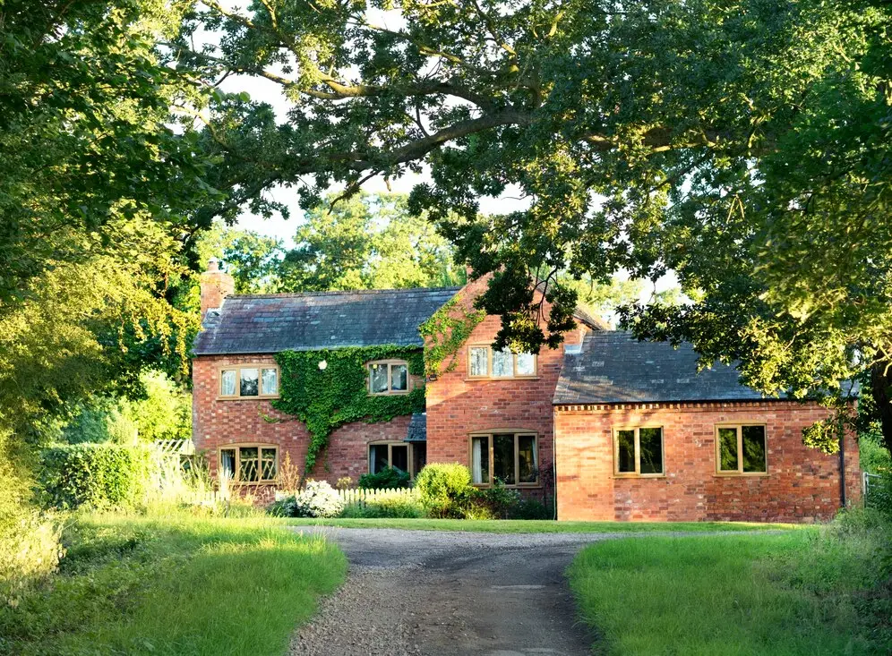 brick retirement village surrounded by green grass and green trees