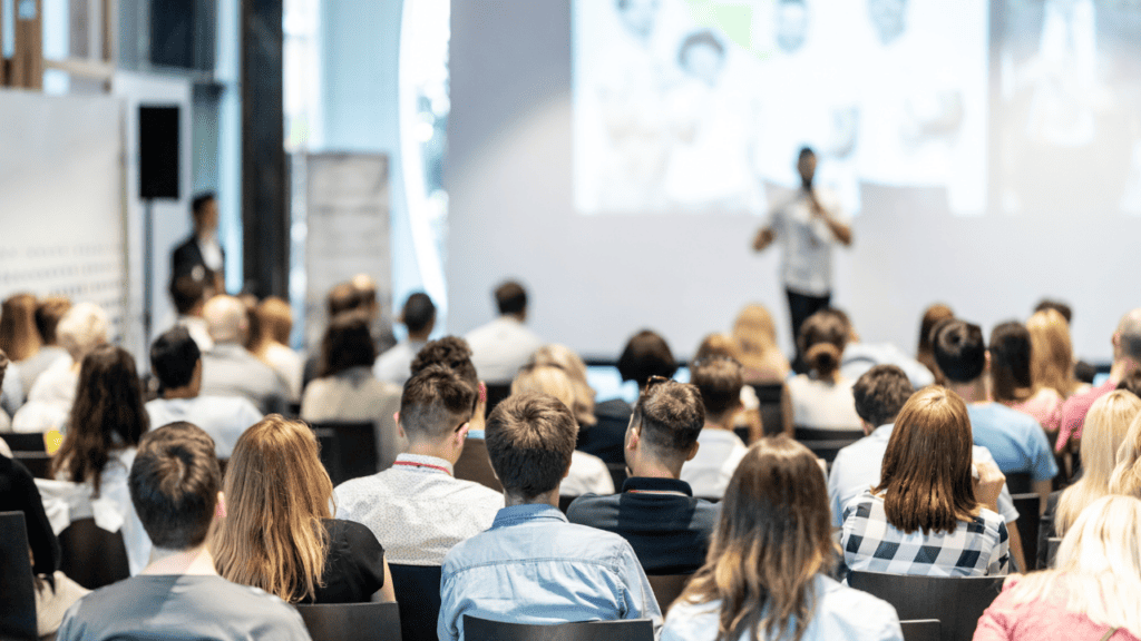 group of people with backs to camera watching presentation